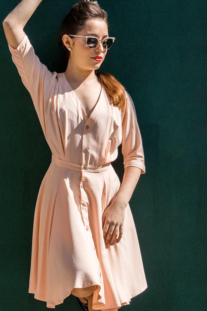 Mr Colette - Girl in pink Almendro Dress on green background for mobile