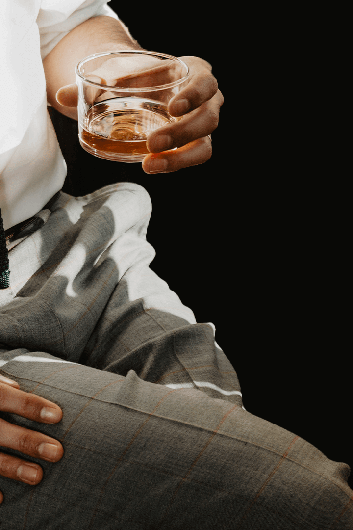 Mr Colette - Guy in custom trousers with Whiskey in hand mobile
